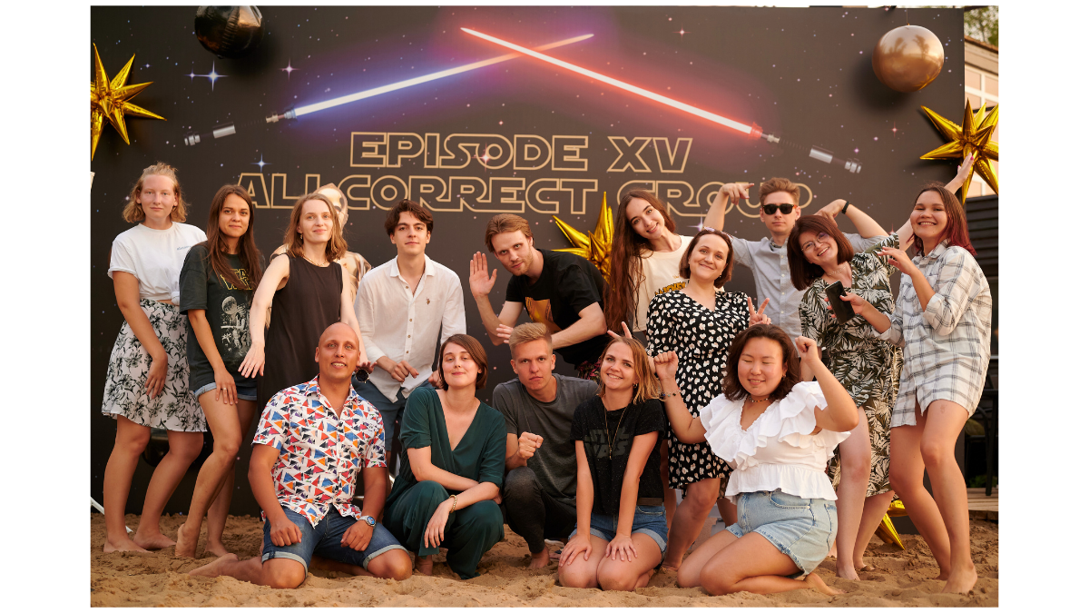 Group photo of a team posing in front of a Star Wars-themed backdrop, celebrating an event.